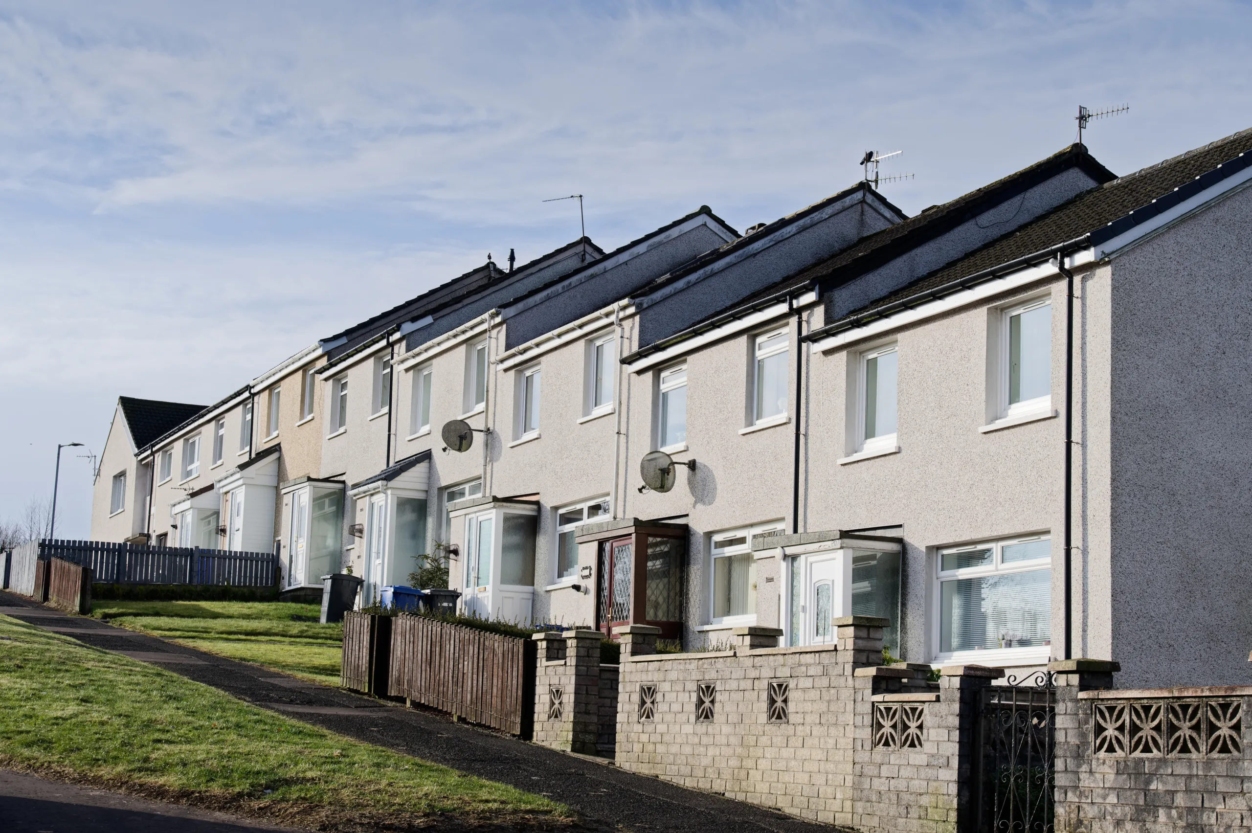 Non-standard construction property. Row of Houses on a small hill on a small housing estate.