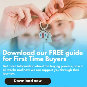 Young couple holding up keys to a camera after buying their first home